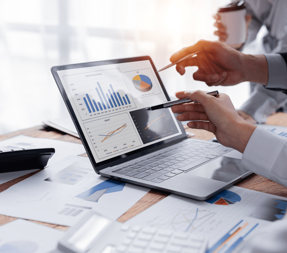 Laptop displaying business charts and graphs.